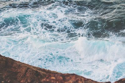 High angle view of waves breaking on beach