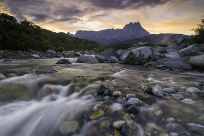 Scenic view of river against sky during sunset