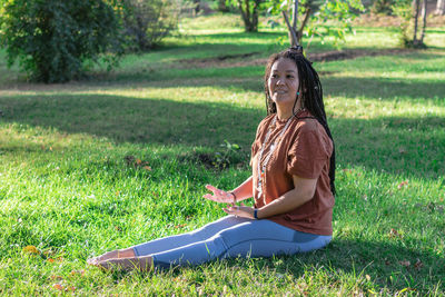 Woman is doing yoga asana outside in a park. concept of balancing and healthy lifestyle.