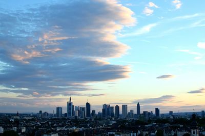 View of cityscape against cloudy sky