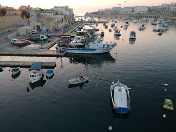 High angle view of boats moored at harbor in city