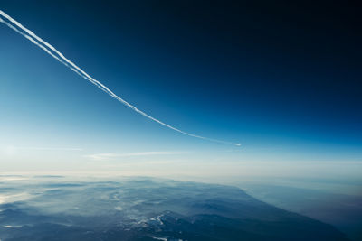 Low angle view of vapor trail