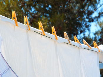 Low angle view of clothes drying on roof against sky