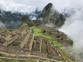 View of castle on mountain against cloudy sky