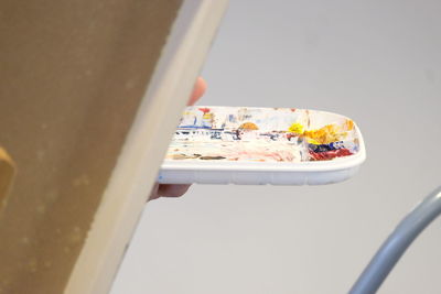 High angle view of cigarette on white wall