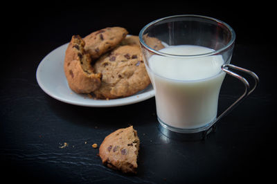 Close-up of cookies with milk on table