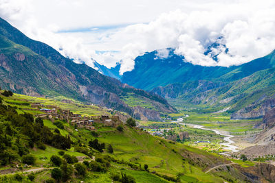 Scenic view of valley and mountains against sky