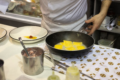 Chef of a restaurant who is going to plate the freshly cooked italian pasta specialty