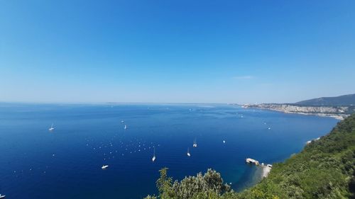 High angle view of sea against clear blue sky