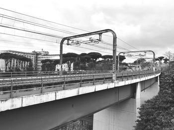Train on railroad bridge against sky
