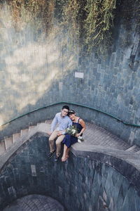 High angle view of people sitting on staircase