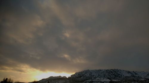 Low angle view of silhouette mountain against sky