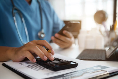 Midsection of man using laptop on table