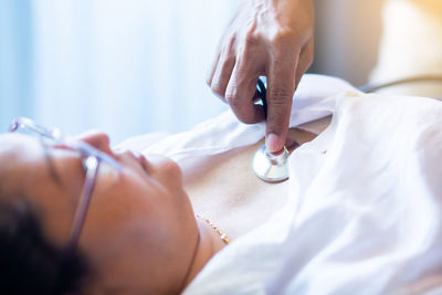 Midsection of woman lying on bed