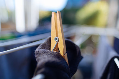 Close-up of wooden clothespin on clothesline