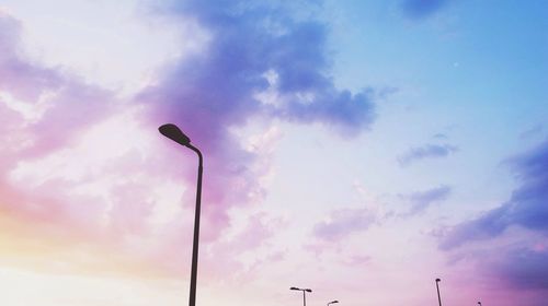 Low angle view of street light against cloudy sky