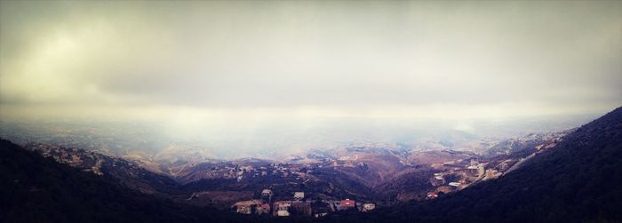 Scenic view of mountains against cloudy sky