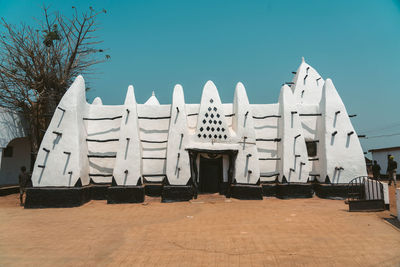 View of buildings against clear blue sky