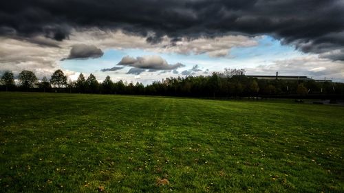 View of soccer field against cloudy sky