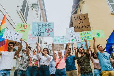 People holding placards with text during protest