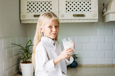 Portrait of smiling girl drinking milk