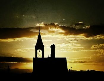 Silhouette of church against sky