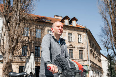 Portrait of a handsome hipster man. a man in a big city cycling down the street on a bicycle