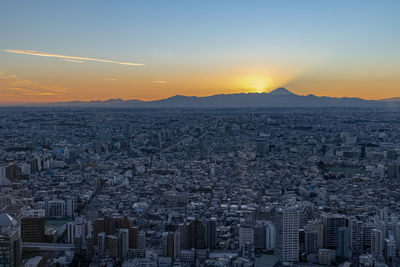Aerial view of townscape against sky during sunset