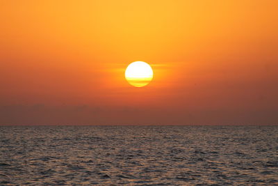 Scenic view of sea against orange sky