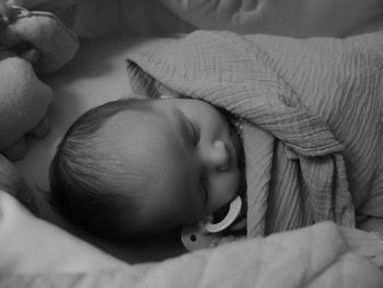 Close-up of baby wrapped in blanket