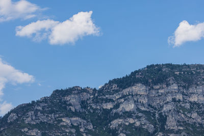 Low angle view of rocky mountains against sky