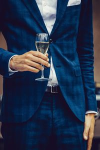 Midsection of a man drinking glass