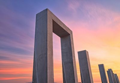 Low angle view of building against sky during sunset