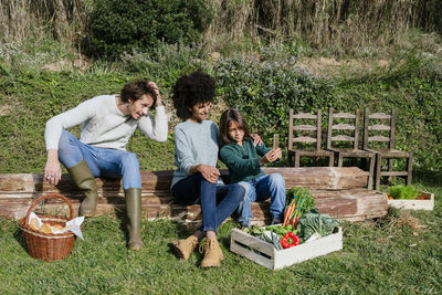 Happy family taking a break after harvesting vegetables, taking selfies