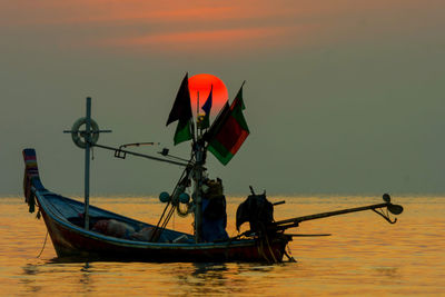 Nautical vessel on sea against clear sky during sunset