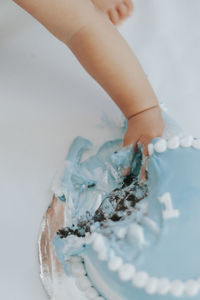 Low section of woman holding dentures
