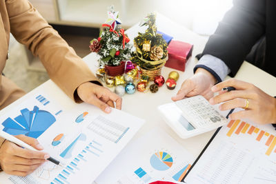 High angle view of hands holding table
