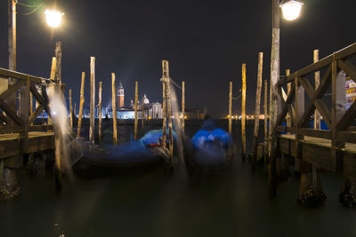 Gondolas at grand canal against sky at night