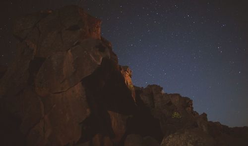 Scenic view of mountains against sky at night