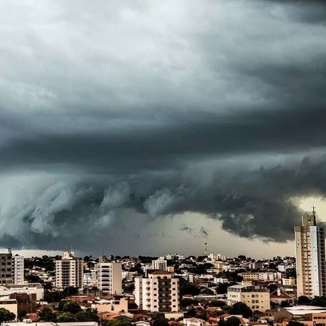 building exterior, architecture, built structure, city, cloud - sky, cloudy, cityscape, sky, weather, overcast, storm cloud, crowded, residential district, residential building, residential structure, cloud, high angle view, skyscraper, city life, outdoors