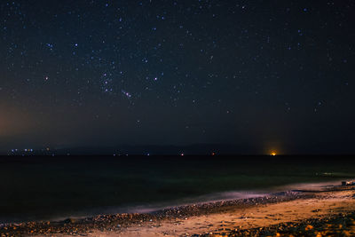 Scenic view of sea against sky at night