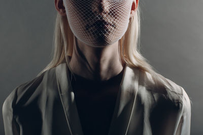 Portrait of beautiful young woman over black background