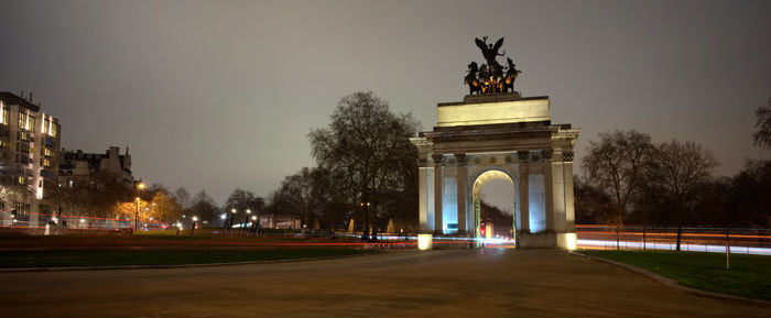 Statue in illuminated city