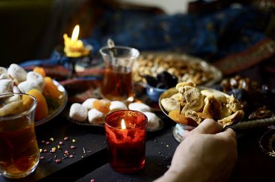 Cropped hand of woman having food on table