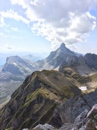 Scenic view of mountains against cloudy sky