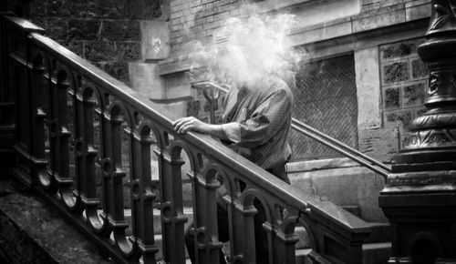 Full length of man moving down on staircase