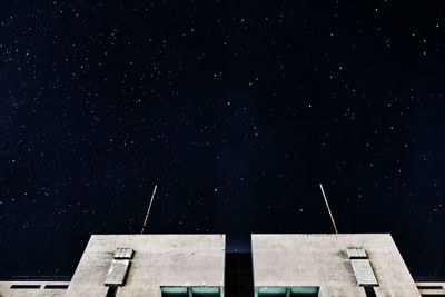 Low angle view of building against star field at night