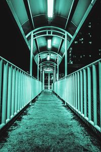 Empty corridor in illuminated building