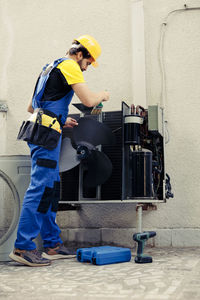 Rear view of man working at construction site