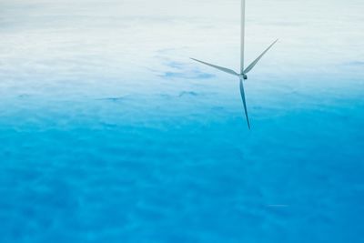 Close-up of wind turbines in sea